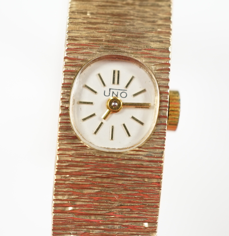 A lady's 1970's 9ct. gold Uno manual wind bracelet wrist watch with a bark textured bracelet, gross weight 24.8 grams.